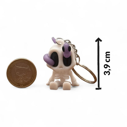 Skelett-Blob-Schlüsselanhänger (weiß/lila) auf weißem Hintergrund, Höhe ca. 3,9 cm; Euro-Münze zum Größenvergleich, Pfeil-Maßangabe, 3D-Druck.