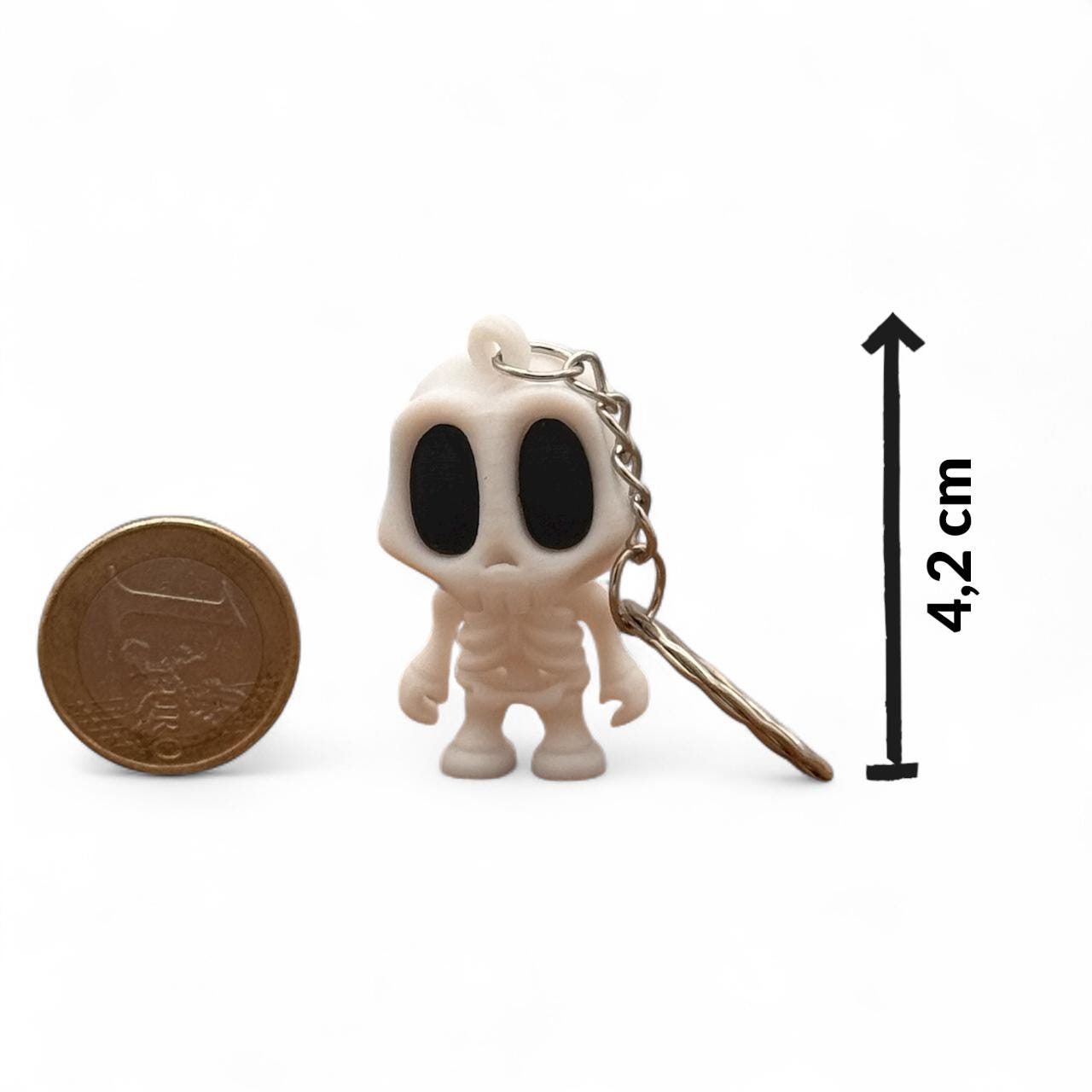 Mini-Skelett-Schlüsselanhänger (weiß) auf weißem Hintergrund, Höhe ca. 4,2 cm; Euro-Münze zum Größenvergleich und Pfeil-Maßangabe, 3D-gedruckt.